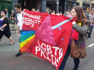 Socialist Party members carry our banner on the parade